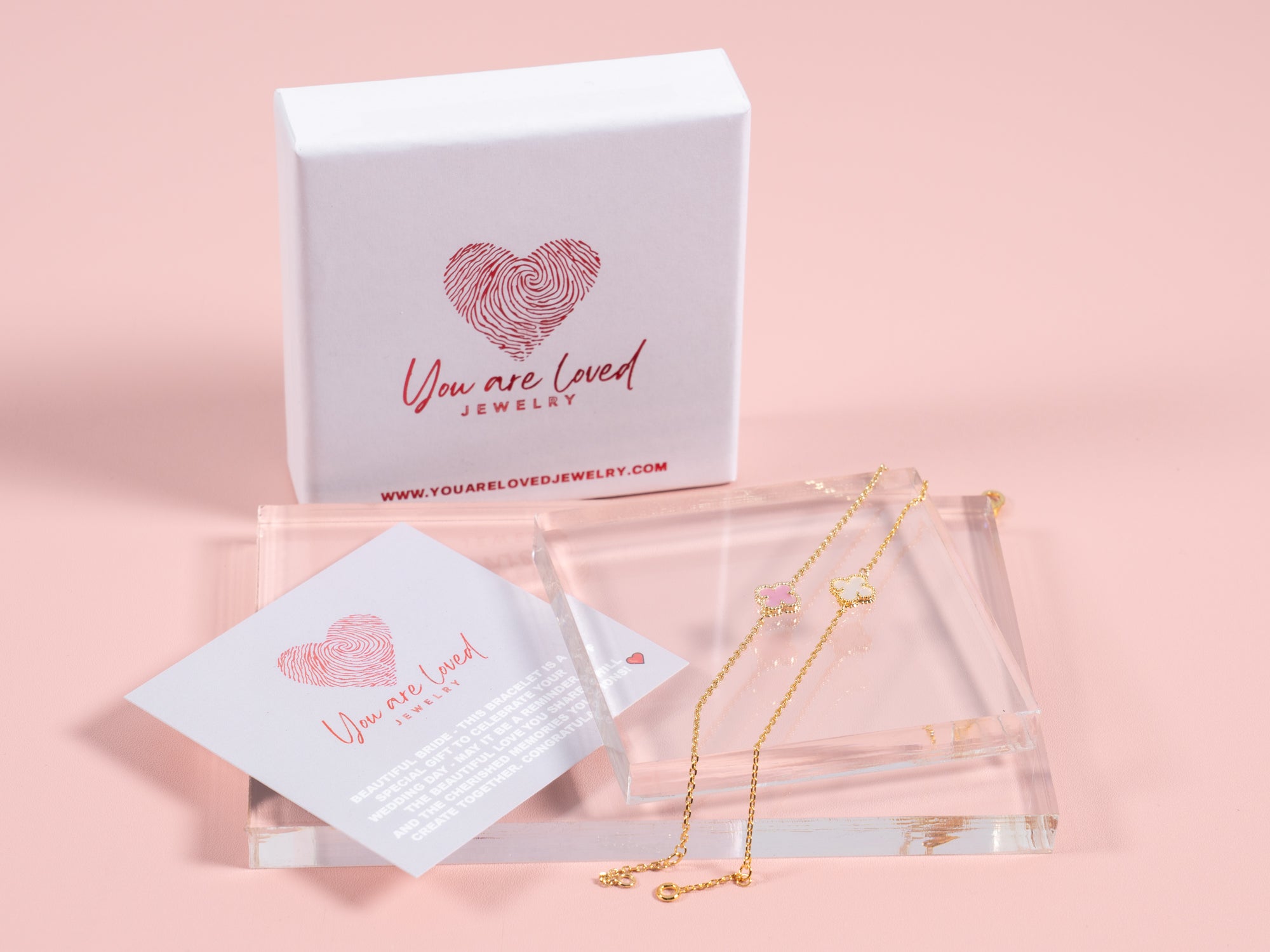 white and pale pink four leaf clover pendant bracelets that can be gifted to the bride for bridal showers or wedding gifts for the bride. Comes with a congrats card as shown in the picture