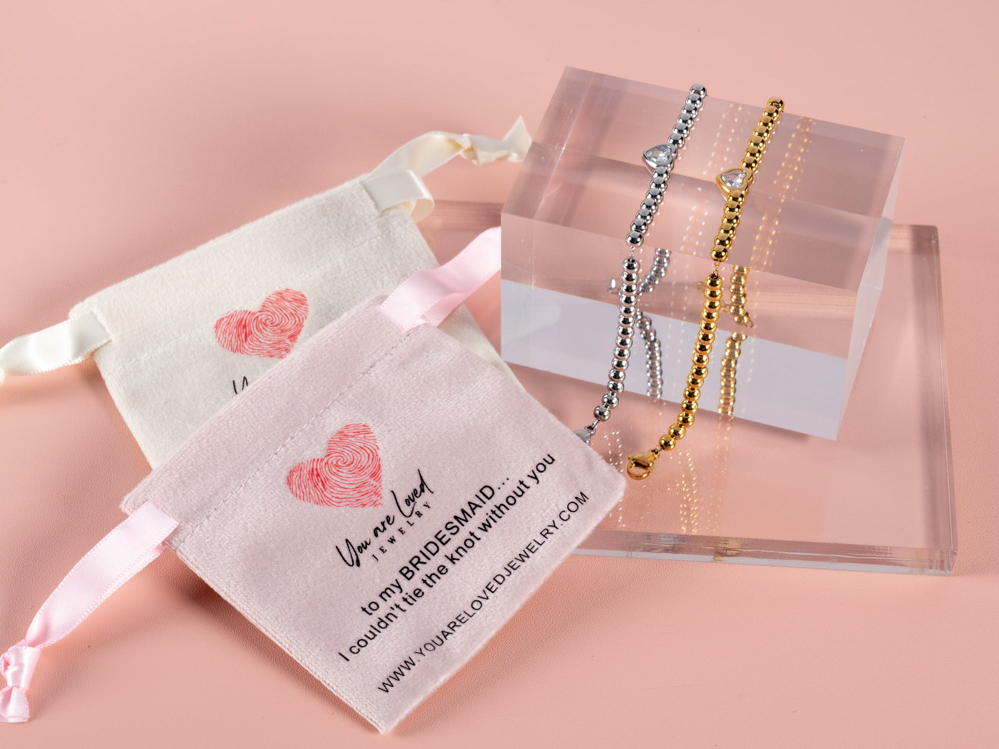 bridesmaid can't tie the knot without you heart gemstone bracelet displayed here with a pink and white velvet pouch - this bracelet is adjustable and can be given as a bridesmaid gift