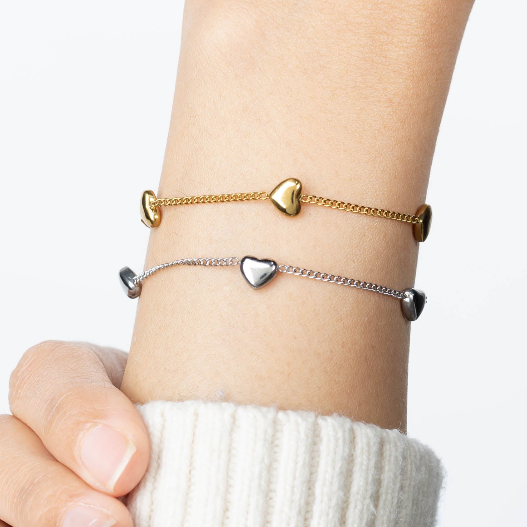 multi heart gift bracelets shown here on a clear cube and a pink bridesmaid can't tie the knot without you gift pouch next to it. These are great gift bracelets for all your bridesmaids