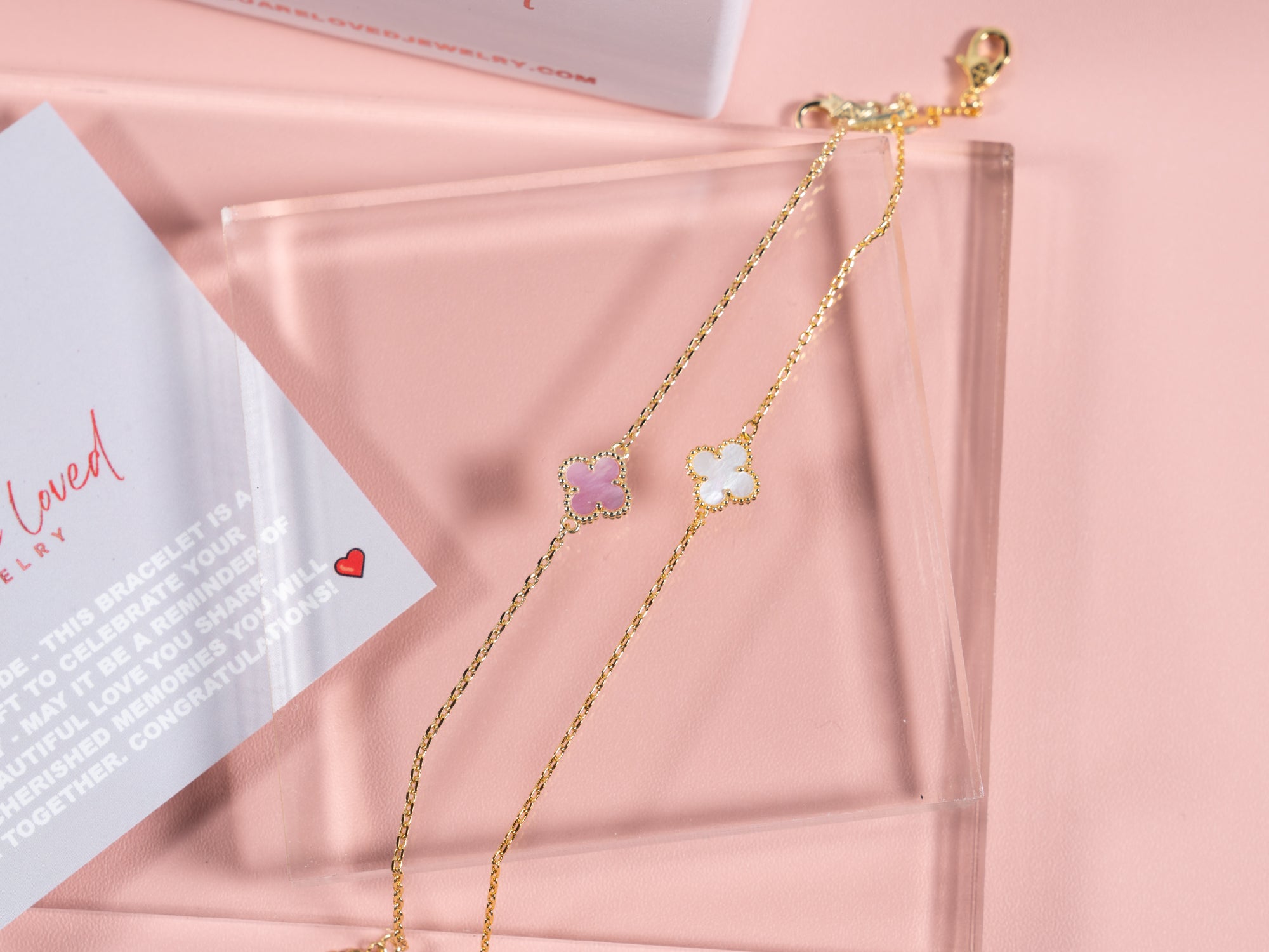 white and pale pink four leaf clover pendant bracelets that can be gifted to the bride for bridal showers or wedding gifts for the bride. Comes with a congrats card as shown in the picture