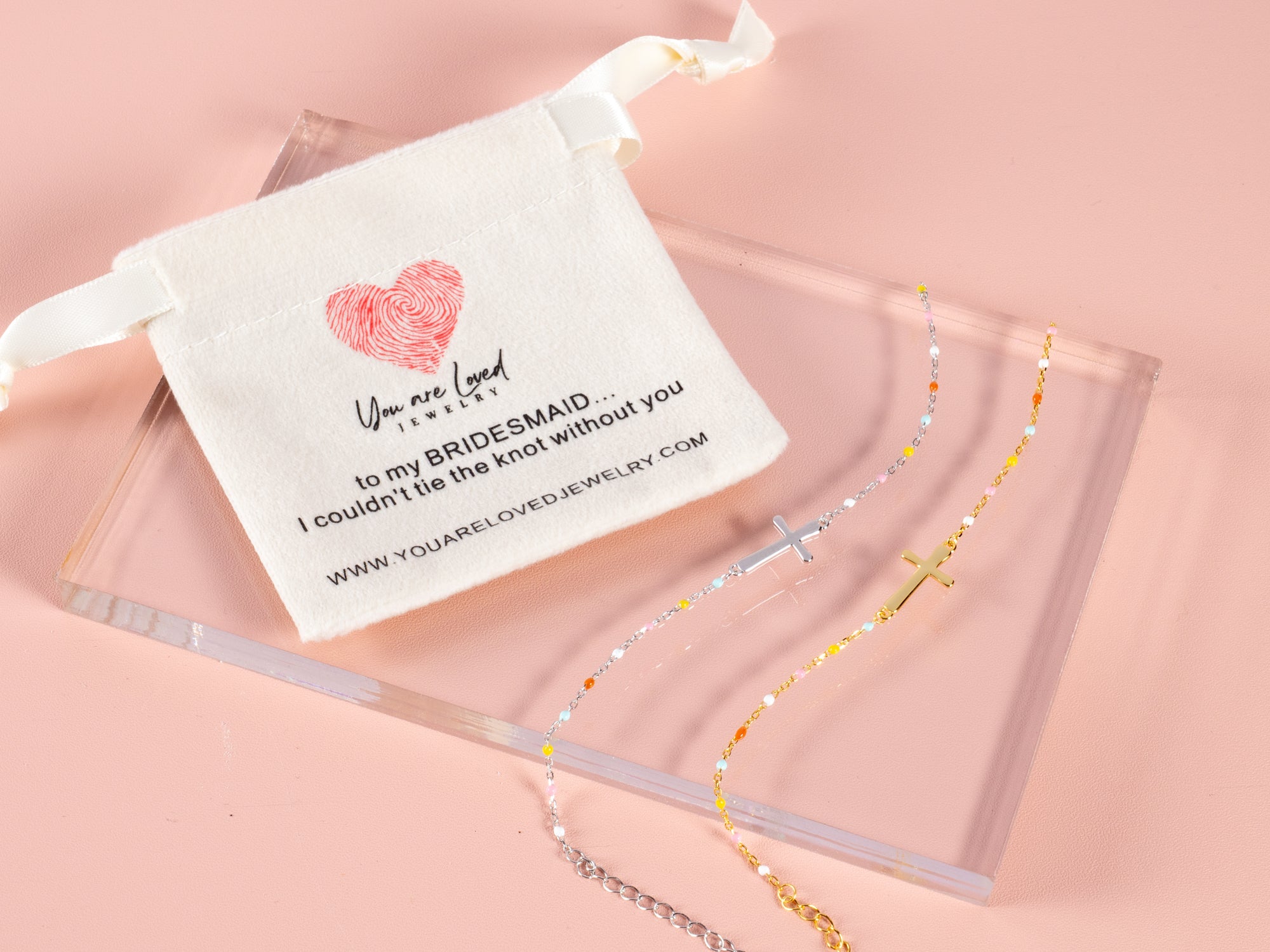 gold and silver cross bracelets shown here with a can't tie the knot without you pouch makes a great gift for a bridesmaid proposal box